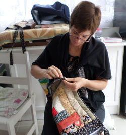 Christine finishing her Binding on Log Cabin