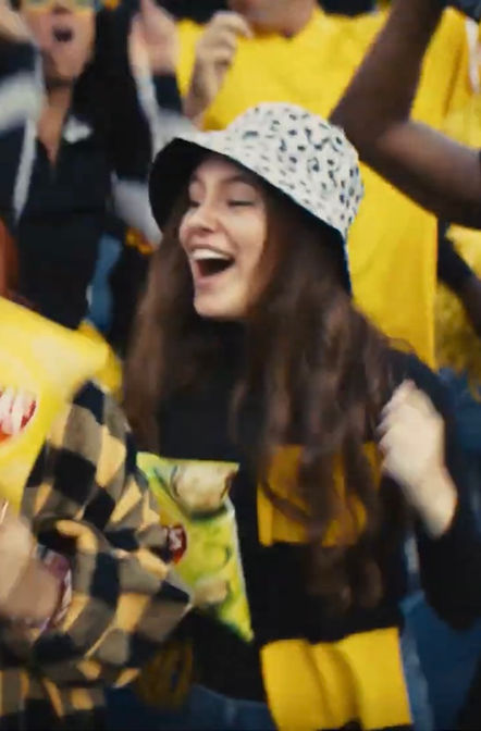 Victoria Nelson laughing with cast on set of Lay’s commercial with Messi.