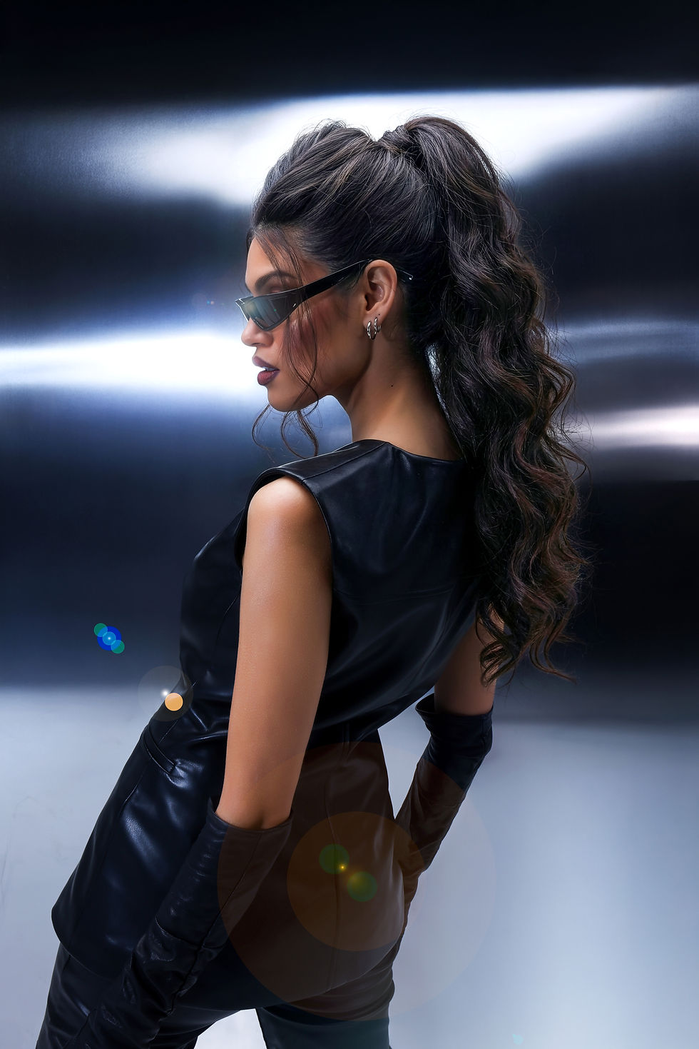 Side view of dark brunette Gold Class Hair extensions styled in a textured high ponytail