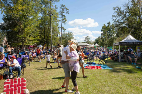Couple embracing at a sunny outdoor festival