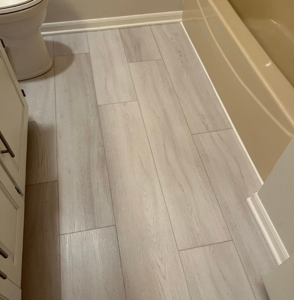 8 New toilet installed after luxury vinyl planking laid. Trim repainted and caulked.