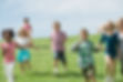 a-group-of-children-running-across-a-grass-field-2022-03-04-02-29-27-utc.jpg