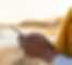 woman using mobile phone on the beach