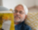 Man wearing glasses reading a book