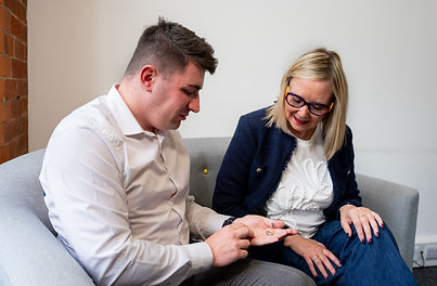 Man and woman looking at hearing aid selection