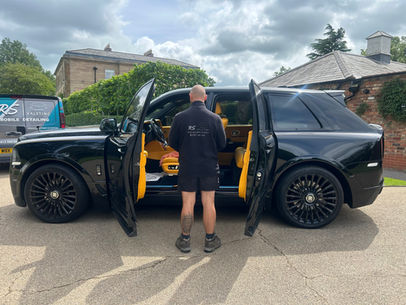 RS Valeting detailer in front of a Rolls Royce Cullinan with the RS Valeting Van behind