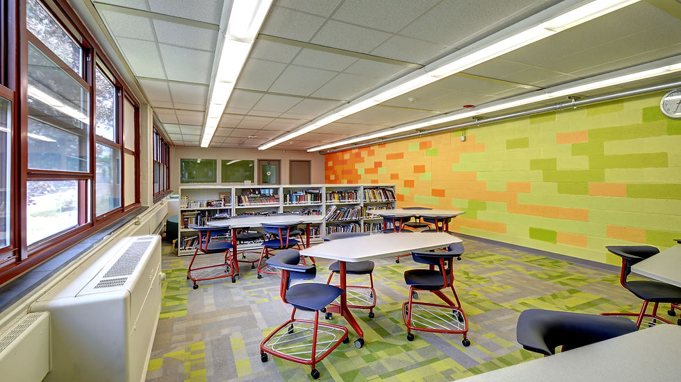 Reimagined Syracuse Charter School library featuring colorful finishes, flexible seating, and student learning areas.