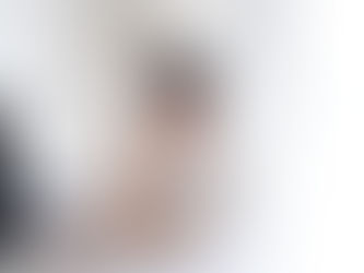 Beverley from Coached by Beverley drinking coffee, sat at her computer