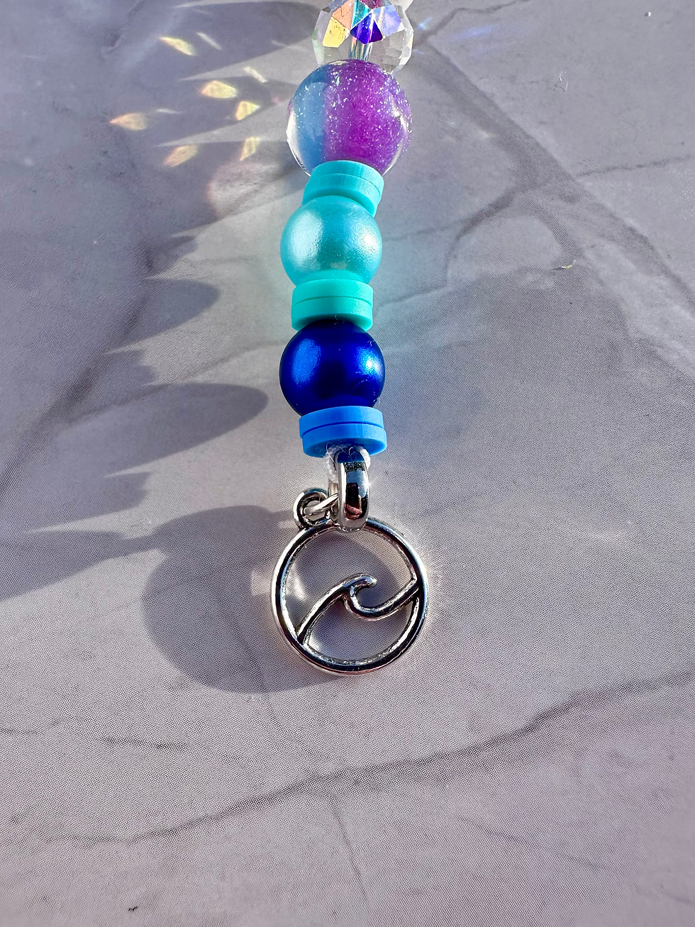 Miniaturbild: Charm hängend am Hooptag mit Welle