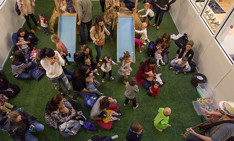 Toddler playing and engaging with props during a live interactive music class for young children