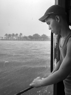 Boy looking out at the ocean in Havana, Cuba, documentary travel photography