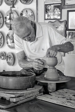 Black and white documentary photograph of a potter's hands at work in Havana, Cuba