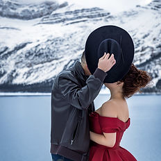 Signature portrait session in the Canadian Rockies featuring elegant subjects against alpine lakes and snow-covered peaks.