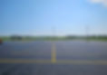 An asphalt parking lot with asphalt sealcoating by The Road Doctor in Monticello, Illinois.