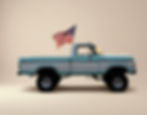 Side view of a blue and white 1978 Ford F-150 displaying an American flag