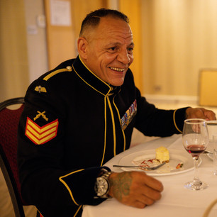 man laughing sat at table