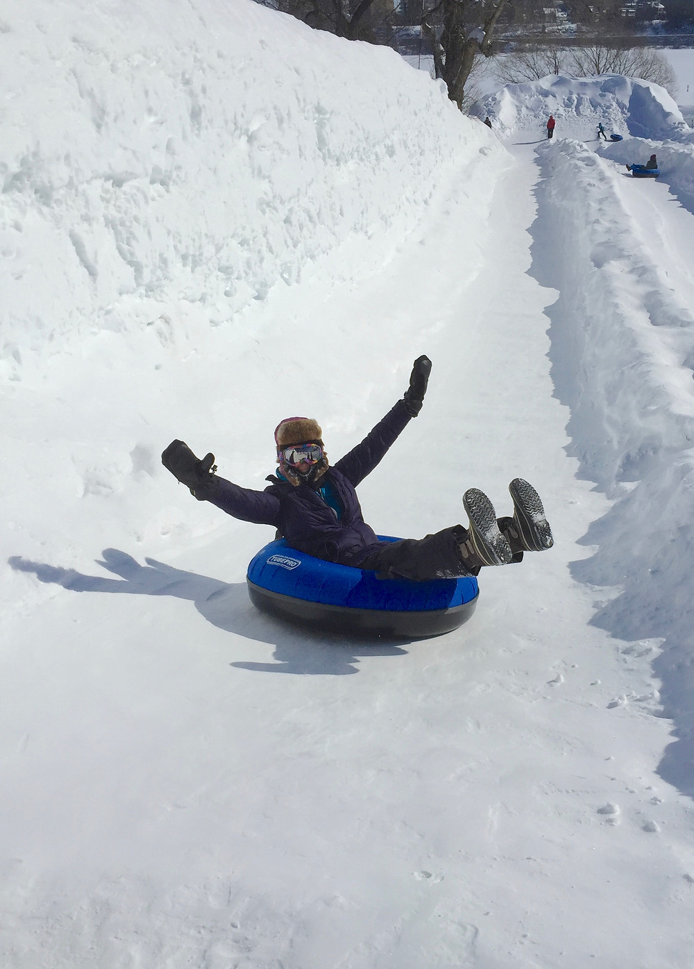 Arms raised while tubing in Quebec, -29 C