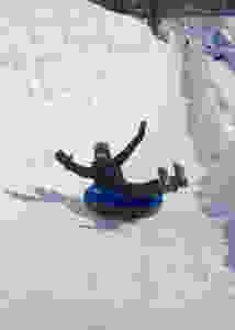 Arms raised while tubing in Quebec, -29 C
