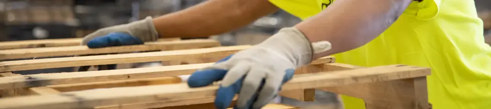 hands lifting pallet - banner