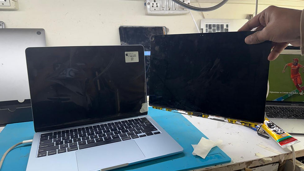 High angle view of a MacBook repair workstation with tools and spare parts arranged neatly