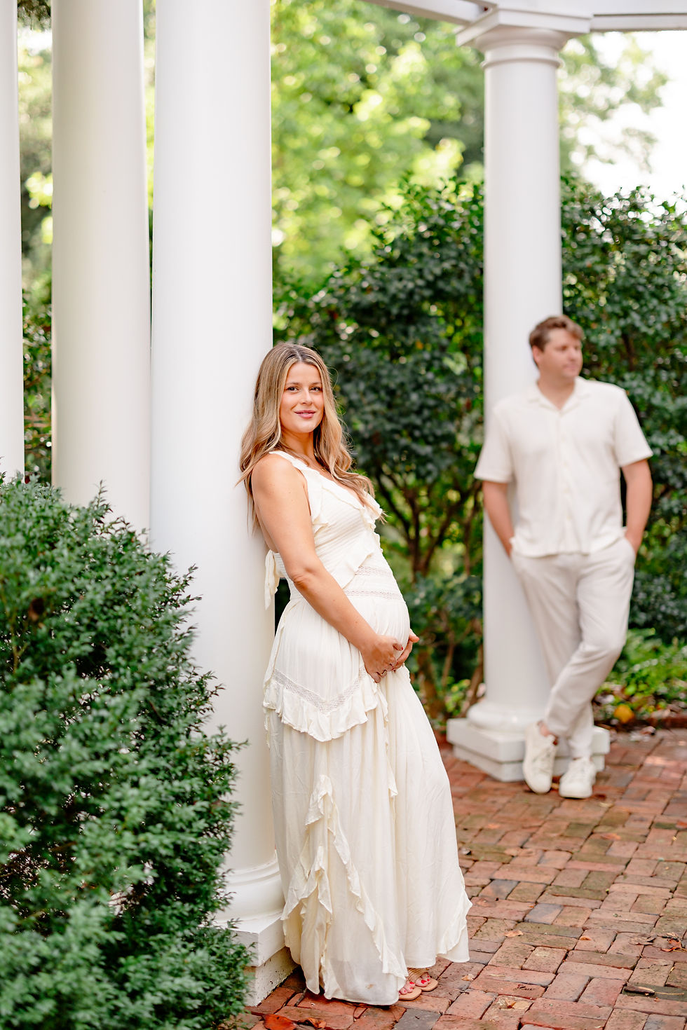 Maternity portrait beside the white columns on the terrace at The Duke Mansion Charlotte