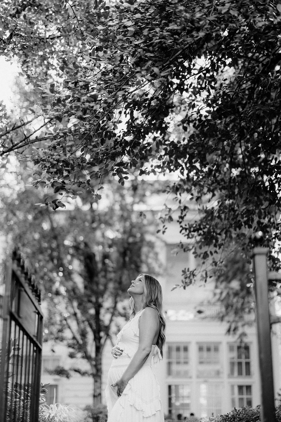 Black and white maternity portrait under the trees in the gardens at The Duke Mansion Charlotte NC