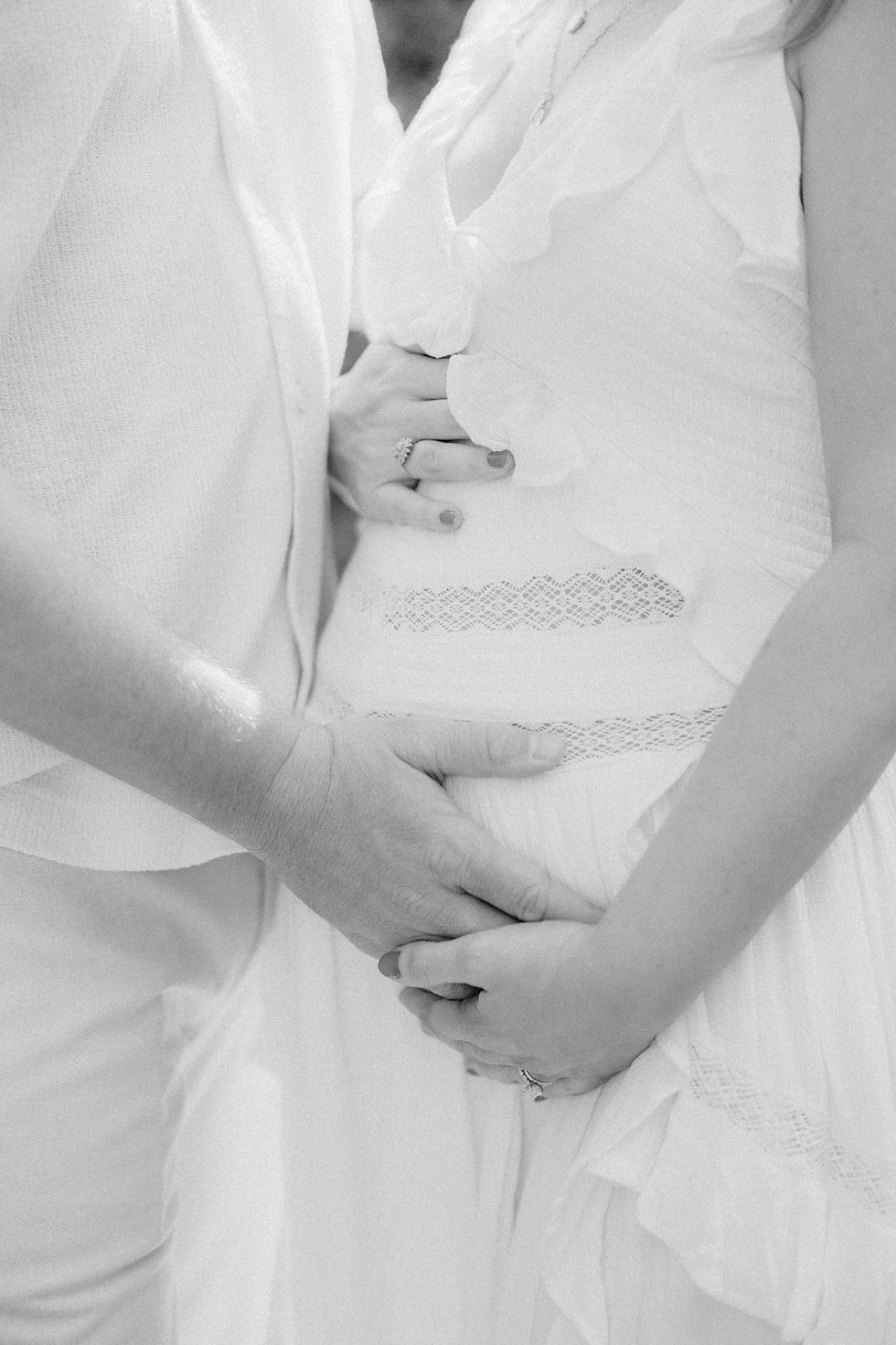 Black and white close up of hands on the baby bump during a Duke Mansion maternity session in Charlotte