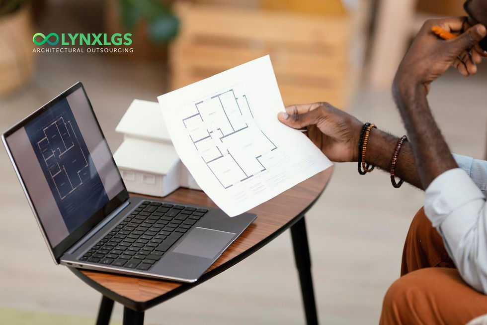 African man working on laptop_holding architecture floor plan
