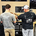 Fuel Outdoor Gear Bow techs working on a compond bow