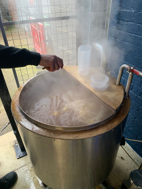 The orange peel being added to the brew