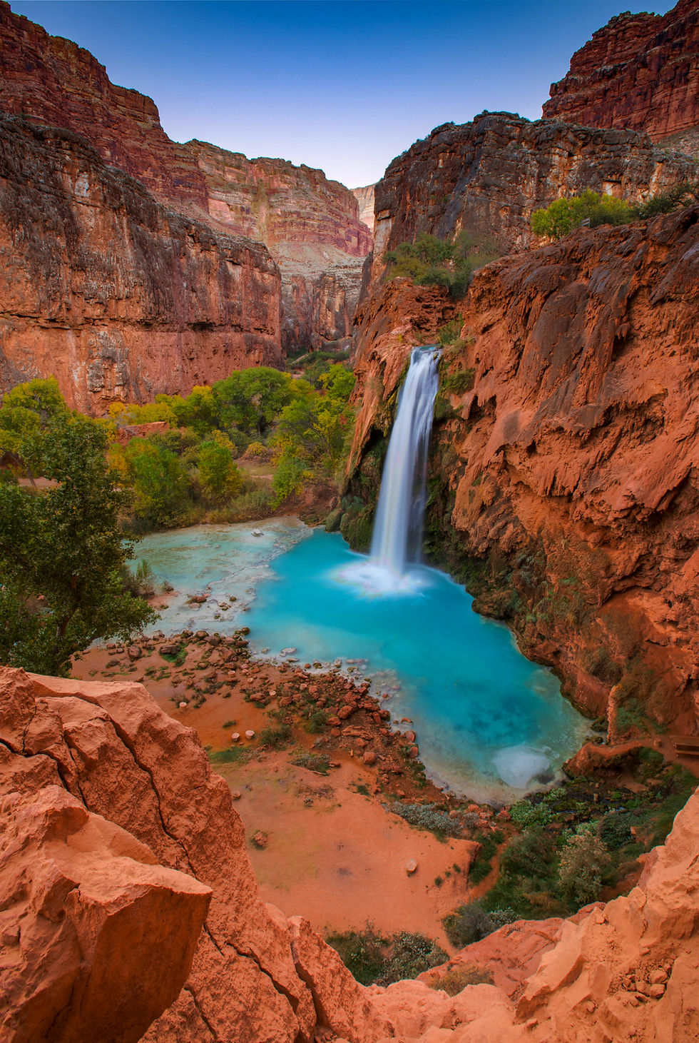 Havasu Falls with turquoise water and red canyon walls on the Havasupai Reservation in Arizona.