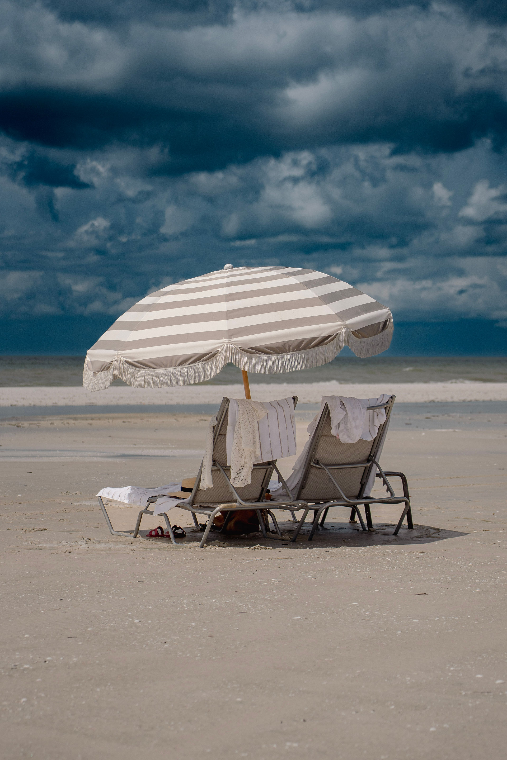 Private beach area with lounge chairs and umbrellas for Paradise by Sirene guests at JW Marriott Marco Island