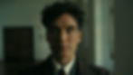 Cillian Murphy as J. Robert Oppenheimer, framed in soft, natural light with a shallow depth of field — showcasing the emotional texture and analog beauty of IMAX 65mm film.