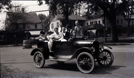 WFG-7 Auto with 1919 license plate, seven persons, at intersection of Whitfield and Boston