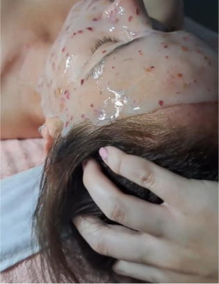 girl having a spa facial with a mask on and scalp massage