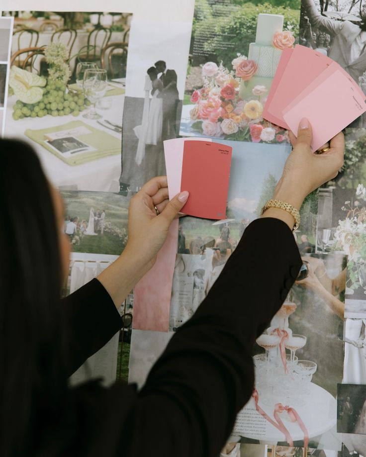 Person holding pink paint swatches against a collage of wedding photos and floral arrangements. Elegant, creative mood.