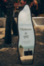 Beach wedding welcome sign beside a palm tree, reading Melissa & JB, with 25 Feb 2026 at Kya Beach House, Koh Samui.