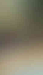 Stone fountains with intricate carvings and orange garlands pour water into a pool. Lush greenery and umbrellas in the background. Text: "Genah Melukat."