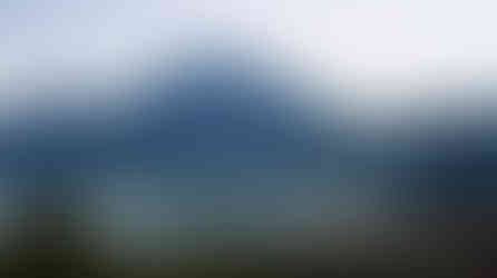 A tranquil view of Trunyan Village in Bali, an ancient settlement known for its unique cultural practices and scenic beauty. The village is located near Lake Batur, offering a peaceful contrast to its haunting reputation