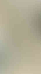 Stone carving of two intricate, crowned figures in traditional dress on a temple wall, displaying serene expressions and delicate patterns.