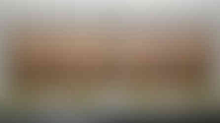 A detailed folding screen with landscape paintings is displayed in a glass case. Beige and brown tones dominate. Documents with text are visible.