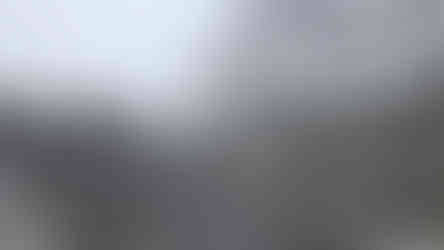 Stone dragon sculpture on misty stone steps, ornate gate with gold text in background. Serene, mystical atmosphere.