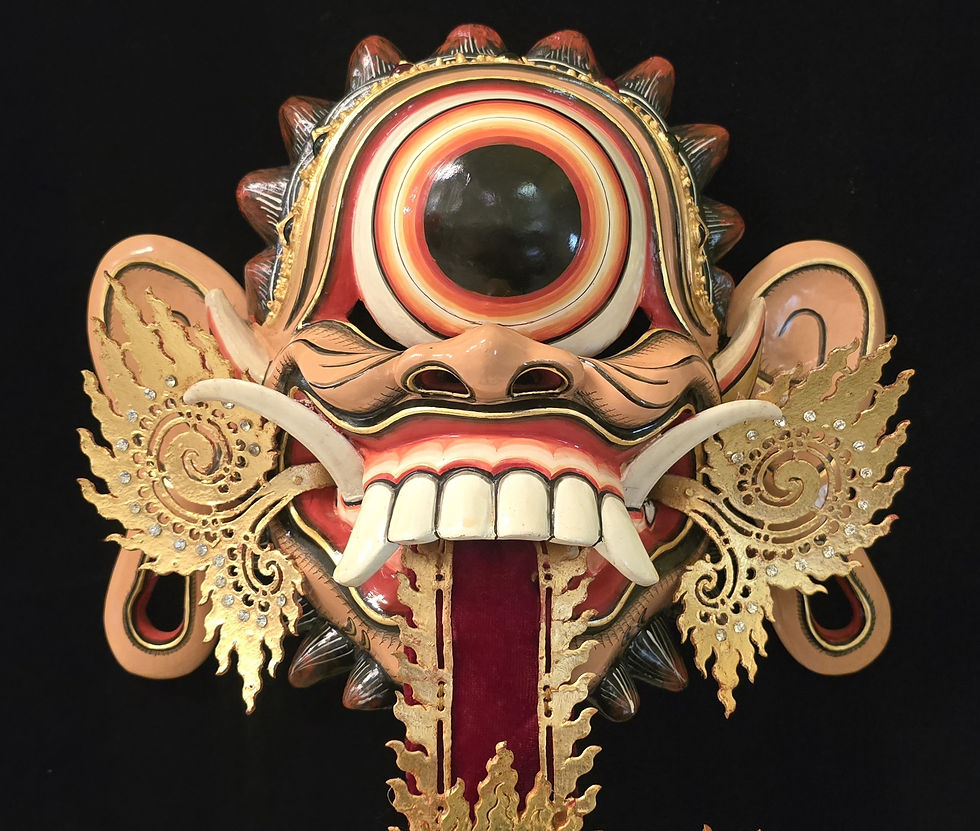 Ornate mask with one large eye, sharp teeth, and golden decorations on a black background. Rich red, gold, and beige colours.