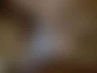 Inside the dark princess cave, gold and white artificial lighting along a small timber railed walkway, textured cave walls