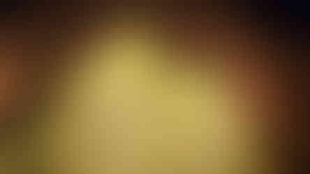 Relief sculpture with golden figures on a textured panel, depicting trees and people under archways. Warm lighting enhances details.