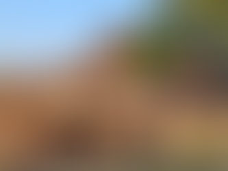 Scattered debris of a fallen temple, surrounded by headless statues