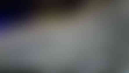 Ancient Chinese calligraphy etched into a vertical rock face near the entrance of the cave