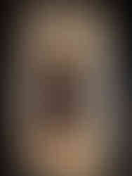 View of a dimly lit sanctuary chamber, with vaulted ceilings supported by thick stone columns, and soft shafts of light