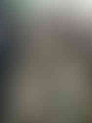 Stone statue of Rangda, the fearsome witch queen of Balinese mythology, with wild hair and protruding fangs.