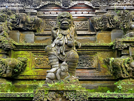 Ornate stone sculpture with intricate carvings, green moss, and mythical figures in a temple setting, evoking a mystical atmosphere.